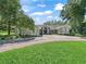 Charming single-story home featuring a circular driveway and mature trees in a lush, green yard at 5714 Nw 80Th Avenue Rd, Ocala, FL 34482