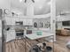 Bright, open kitchen with white cabinets, stainless steel appliances, and an island with seating and ample workspace at 5714 Nw 80Th Avenue Rd, Ocala, FL 34482