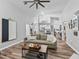 Open-concept living room with high ceilings, wood floors, and seamless flow into the kitchen and dining areas at 5714 Nw 80Th Avenue Rd, Ocala, FL 34482
