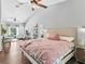 Spacious main bedroom with high ceilings, wood floors, and a seating area, offering a luxurious retreat at 5714 Nw 80Th Avenue Rd, Ocala, FL 34482