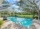 Sparkling pool with a screened enclosure offers a refreshing oasis and backyard views at 5714 Nw 80Th Avenue Rd, Ocala, FL 34482