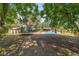 Large backyard with a pool, palm trees, and trampoline, perfect for outdoor activities at 6060 Se 119Th Pl, Belleview, FL 34420