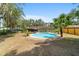 Backyard with a pool, a covered patio, tropical plants, and plenty of space to relax at 6060 Se 119Th Pl, Belleview, FL 34420