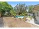 Backyard oasis with mature tropical plants, a pool, patio, and a lush private backyard at 6060 Se 119Th Pl, Belleview, FL 34420