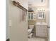 Compact bathroom with a single vanity, decorative jewelry rack, and a tiled floor at 6060 Se 119Th Pl, Belleview, FL 34420