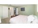 Bedroom featuring neutral walls, carpeted floors, a large window, and access to the bathroom at 6060 Se 119Th Pl, Belleview, FL 34420