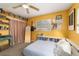 Bright bedroom features unique floor mattress, guitar, and book shelves at 6060 Se 119Th Pl, Belleview, FL 34420