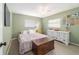 Comfortable bedroom with a ceiling fan, carpeted flooring, and natural light streaming through the windows at 6060 Se 119Th Pl, Belleview, FL 34420
