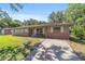 Inviting one-story home with brick accents, a welcoming bench, and a well-manicured lawn at 6060 Se 119Th Pl, Belleview, FL 34420