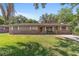 Charming single-story home with brick accents, a green lawn, and white shutters at 6060 Se 119Th Pl, Belleview, FL 34420