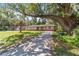 Charming single-story home with brick accents, a long driveway, and mature trees shading the front yard at 6060 Se 119Th Pl, Belleview, FL 34420