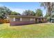Charming single-story home with brick accents, a green lawn, and white shutters at 6060 Se 119Th Pl, Belleview, FL 34420