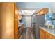 Functional kitchen with stainless steel appliances, light wood cabinetry, and durable granite countertops at 6060 Se 119Th Pl, Belleview, FL 34420