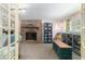 Cozy living room with a brick fireplace and a well-stocked bookcase at 6060 Se 119Th Pl, Belleview, FL 34420