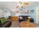 Charming living room with a leather couch, wood floors, and bright, airy feel at 6060 Se 119Th Pl, Belleview, FL 34420