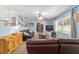 Comfortable living room with a ceiling fan, blue walls, and view of a fireplace and TV area at 6060 Se 119Th Pl, Belleview, FL 34420