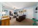 Bright living room with blue walls, cozy furniture, and a ceiling fan for added comfort at 6060 Se 119Th Pl, Belleview, FL 34420