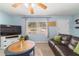 Bright living room featuring large windows, comfortable seating, and a television at 6060 Se 119Th Pl, Belleview, FL 34420