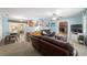Bright and airy living room with ceiling fan and a view into the dining area and kitchen at 6060 Se 119Th Pl, Belleview, FL 34420