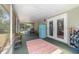 Bright patio features screened windows, colorful rug, and modern decor at 6060 Se 119Th Pl, Belleview, FL 34420