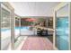 Bright patio features screened windows, colorful rug, and seating near the pool at 6060 Se 119Th Pl, Belleview, FL 34420