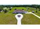 Expansive property featuring a stunning white home, extensive green spaces, and equestrian facilities at 6160 W Highway 326, Ocala, FL 34482