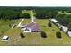 A wide aerial shows the extensive property, detailed landscaping, and structures in a pastoral setting at 6160 W Highway 326, Ocala, FL 34482