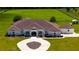 A detailed aerial view shows the property’s landscape, circular driveway, and well-maintained lawn at 6160 W Highway 326, Ocala, FL 34482