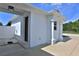 Exterior view of a white structure with columns, a black door, and neutral color concrete at 6160 W Highway 326, Ocala, FL 34482
