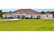 Spacious single-story home boasts a manicured lawn and classic white exterior at 6160 W Highway 326, Ocala, FL 34482