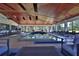 Large indoor pool area with lounge chairs, a dining area, and a unique wood ceiling design at 6160 W Highway 326, Ocala, FL 34482