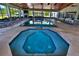 Enjoy a luxury indoor pool and spa area with a spacious lounging and dining area at 6160 W Highway 326, Ocala, FL 34482