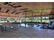 Spacious indoor pool area featuring a high wood ceiling, large windows, and comfortable lounging at 6160 W Highway 326, Ocala, FL 34482