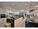 This chef's kitchen offers white cabinets, marble countertops, and high-end appliances at 6160 W Highway 326, Ocala, FL 34482