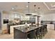 A gourmet kitchen is displayed with marble counters, an island with seating, and stainless steel appliances at 6160 W Highway 326, Ocala, FL 34482