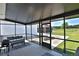 Covered patio with outdoor furniture, a grill, and a view of the green backyard at 6160 W Highway 326, Ocala, FL 34482