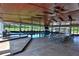 Indoor pool area with covered ceiling and views of exterior grounds at 6160 W Highway 326, Ocala, FL 34482