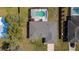 Aerial view of the home's roof, landscaping, and nearby swimming pool at 6211 Se 126Th St, Belleview, FL 34420