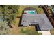 Aerial view of the home's roof, landscaping, a pool and a shed at 6211 Se 126Th St, Belleview, FL 34420