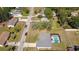 Aerial view showcasing the house, neighborhood, and enclosed pool at 6211 Se 126Th St, Belleview, FL 34420