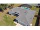 Aerial view of the house showcasing a pool with screened-in enclosure and well-manicured landscaping at 6211 Se 126Th St, Belleview, FL 34420