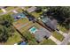 Drone view showing the home, screened pool, and surrounding neighborhood with mature trees at 6211 Se 126Th St, Belleview, FL 34420