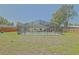 Expansive backyard features a large screened-in pool enclosure and a storage shed at 6211 Se 126Th St, Belleview, FL 34420