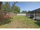 Spacious backyard featuring a well-maintained lawn, and fenced perimeter, providing privacy and room to play at 6211 Se 126Th St, Belleview, FL 34420