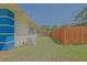 View of fenced backyard with green grass, generator, and air conditioning unit at 6211 Se 126Th St, Belleview, FL 34420