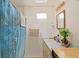 Functional bathroom with a skylight above the shower-tub and vintage vanity at 6211 Se 126Th St, Belleview, FL 34420