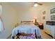 Bedroom with a patchwork quilt bed, soft natural light and wood-look floors under a spinning ceiling fan at 6211 Se 126Th St, Belleview, FL 34420