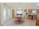 Cozy dining area featuring wood floors, a rustic table set, and plenty of natural light from the nearby windows at 6211 Se 126Th St, Belleview, FL 34420