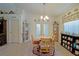 Cozy dining room with wood floors, decorative shelving, a modern light fixture, and natural light at 6211 Se 126Th St, Belleview, FL 34420