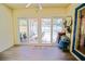 Enclosed sunroom featuring sliding glass doors opening to pool and backyard area, ceiling fan and wood-look floors at 6211 Se 126Th St, Belleview, FL 34420